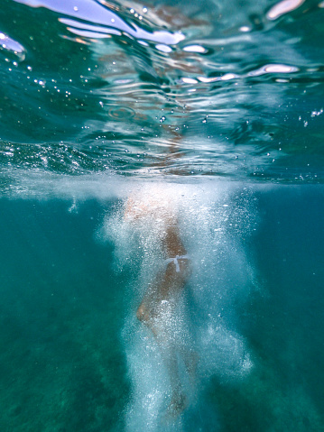 Woman jumping in the water