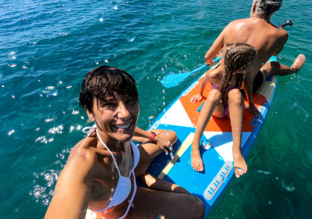 istock Happy Family enjoying on paddling board 1474626432