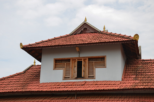 Traditional architecture of a tiled roof house in Kerala, using mainly wood Mangalore Tiles