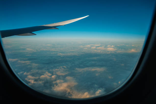 istock View from airplane window. Looking Out the Window of a Plane, Cloudscape. 1474628027
