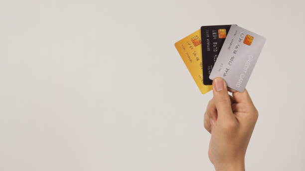 istock Hand is hold three credit cards on white background. 1474631821