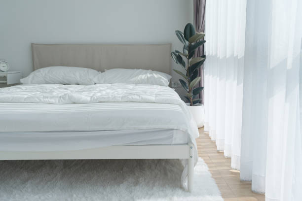 istock White bedroom with white curtains and white pillows 1474633551