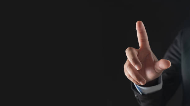 istock Businessman hand touching virtual screen on black background 1474633767