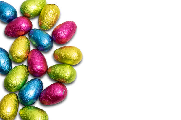 istock Chocolate Easter eggs wrapped in colorful foil isolated on white background. 1474634832
