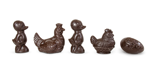 A row of delicious dark brown shiny Belgian chocolate Easter figures. Isolated on white background. Easter concept.