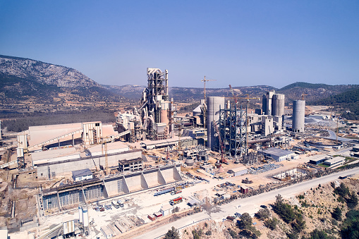 Structures of cement producing plant. Aerial view of huge industrial factory.