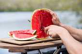 Cutting up Fresh Watermelon by the Lake