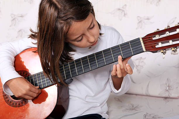 istock Young girl play classical guitar 147463869