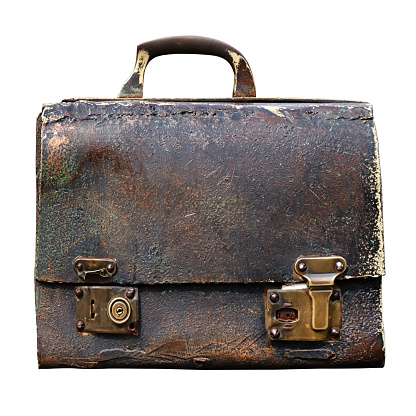 Close-up of an antique briefcase with bronze locks and vintage texture. Isolated on white background.