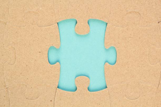 istock Incomplete and absence carton puzzle piece with blue backdrop. Missing piece. Mental health concept. Symbol of problem solving 1474644556