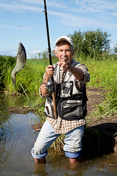 istock Fisherman fly fishing in a lake 147464531
