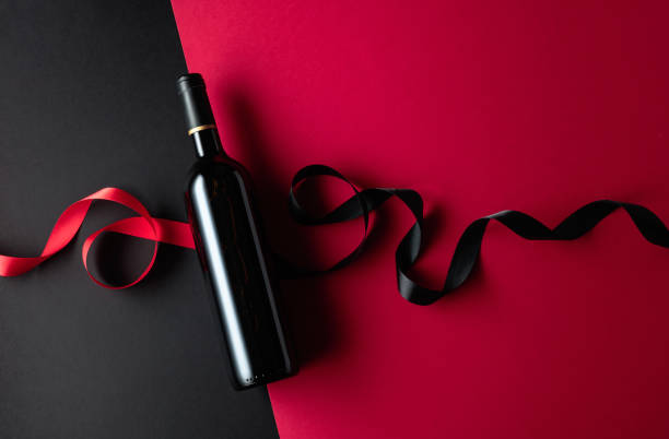 istock Bottle of red wine with satin ribbons. 1474646904