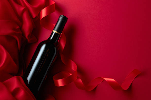 istock Bottle of red wine on a red background. 1474646917