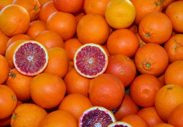 istock background of many ripe orange oranges and two halves open 1474647009