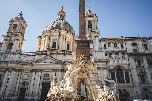 Fountain of the Four Rivers with an Egyptian obelisk and Sant Agnese Church on the famous Piazza Navona Square, Rome, Italy.