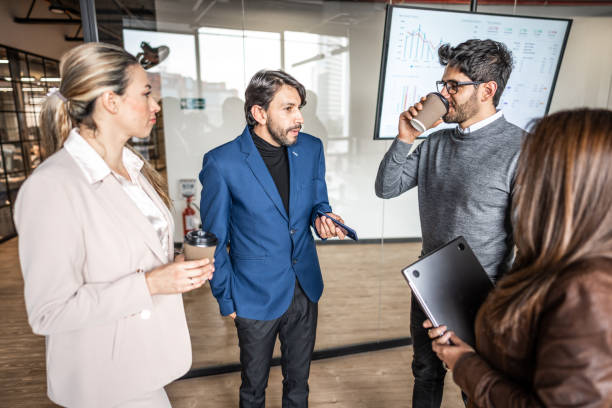istock Coworkers talking on a informal meeting at office 1474651499