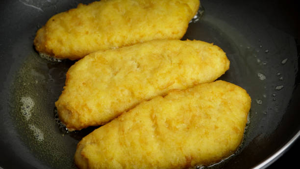 istock several breaded fish, close-up, in a frying pan 1474655900