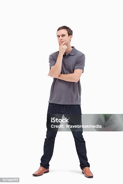 Thoughtful Standing Man With His Legs Apart Stock Photo - Download Image Now - Arms Crossed, Asking, Brown Hair