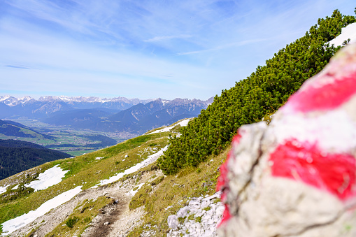 Great view of a trail marked with an Austrian flag, near Innsbruck, tyrol, Austria