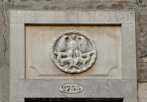 Venice, Veneto, Italy - 08 26 2022: This bas-relief is located in the sestiere of San Polo.