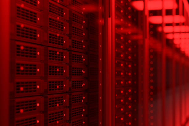istock Rows of server racks in red illumination 1474664952