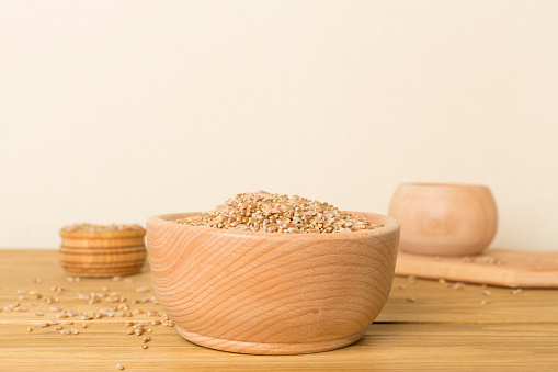 Bowls with wholegrain spelt farro on wooden table.