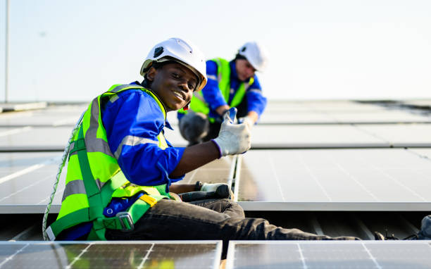 istock Technicians workers with safety uniform checking photovoltaic panels 1474686211