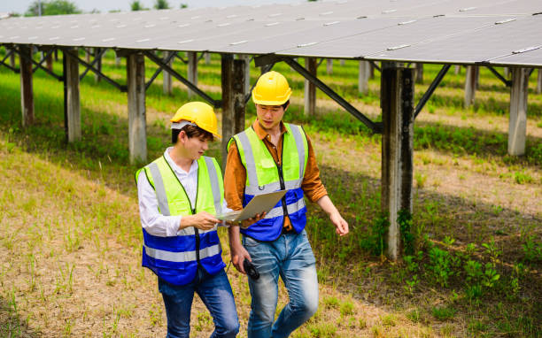 istock Maintenance engineer checking and maintaining solar panels on solar cell farm 1474689249