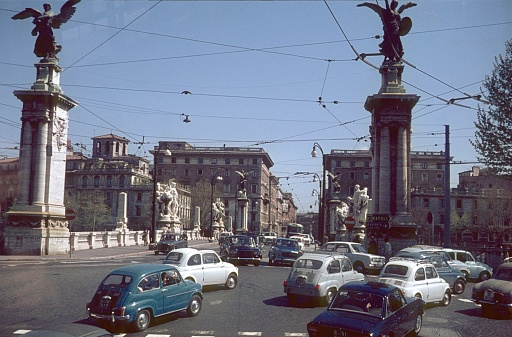 Rome, Lazio, Italy, 1966. Street scene at Ponte Vittorio Emanuele II in Rome. Also: pedestrians, vehicles and buildings.