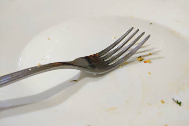 istock A dirty plate with a fork after eating in a restaurant. 1474693456