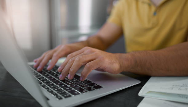 istock Hands, laptop and keyboard with man typing, working and copywriter writing article, internet research and closeup. Copywriting, creative and SEO, digital marketing worker with pc and wifi connection 1474693940