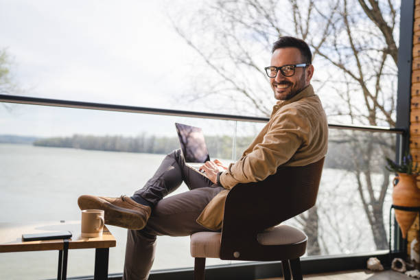 istock man caucasian work on laptop computer on terrace happy smile success 1474701643