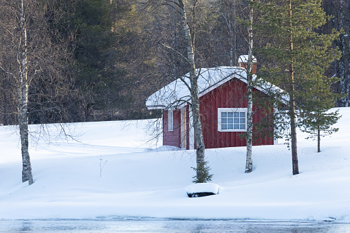 A small read building on a crispy winter day near Kuusamo, Northern Finland