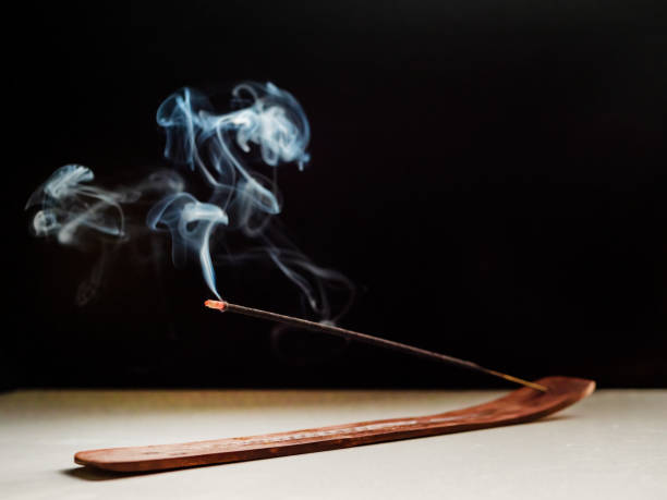 istock Stick Holder and Incense Stick with Smoke on Dark Background. 1474710904