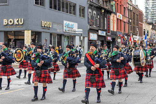 Toronto, Canada - March 19, 2023 : Toronto Fire Services pipe and drum band marching at the annual St Patrick's Day parade