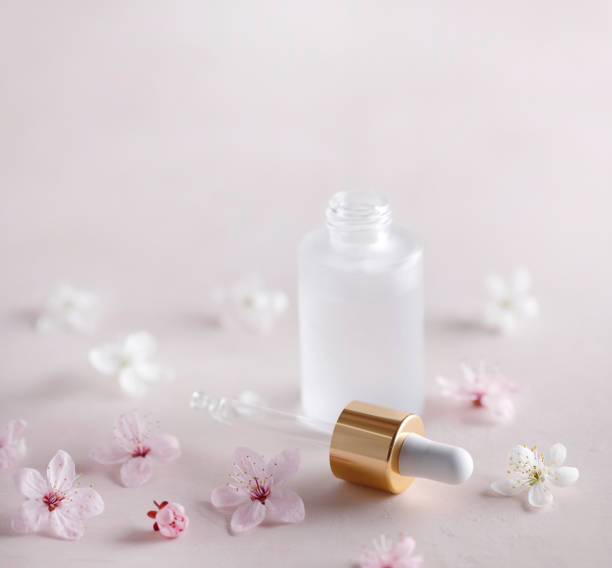 istock Face serum bottle with dropper and flowers 1474715831