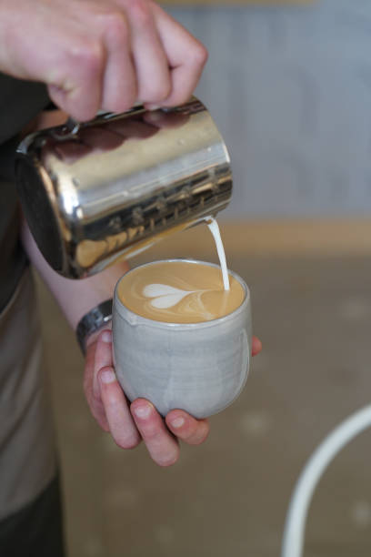 istock Barista making art coffee latte, close-up 1474721696