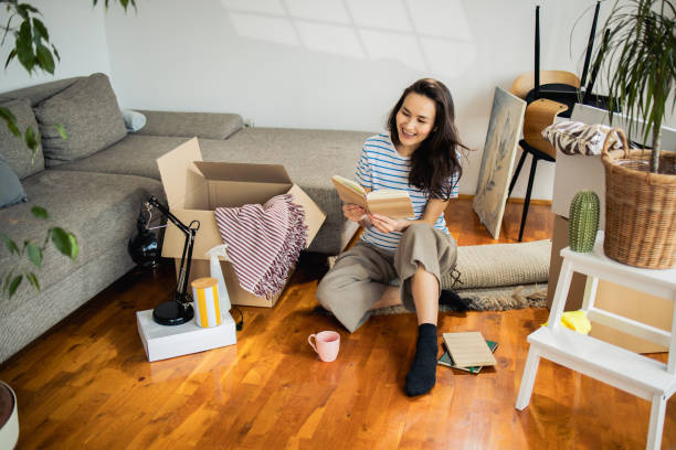 istock Woman enjoying reading at home 1474721872