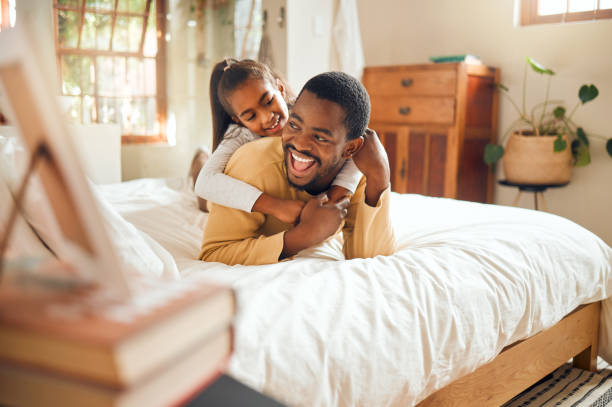 istock Happy, playing and father and daughter in bedroom for bonding, support and affectionate. Smile, happiness and laughing with dad and child in black family home for care, quality time and playful 1474723731