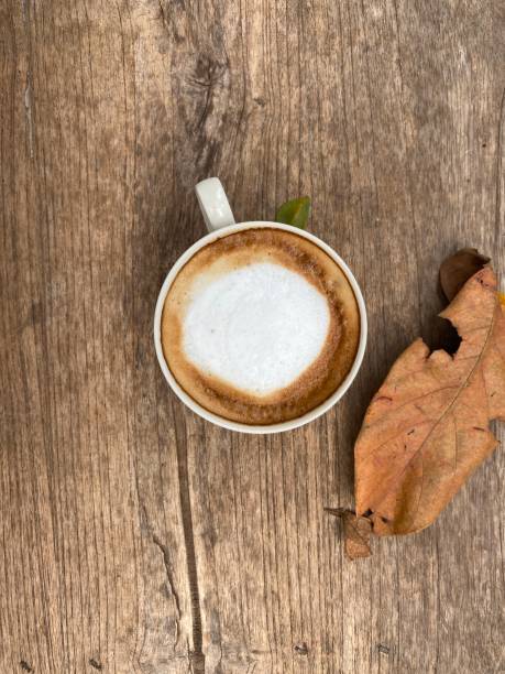 istock Cup of coffee on wooden table, top view 1474727445