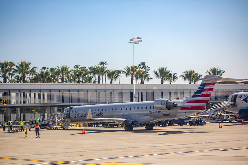 American Eagle Bombardier CRJ-900LR aircraft with registration N329MS operated by Mesa Airlines parked at gate at Long Beach Airport in Feb 2022.