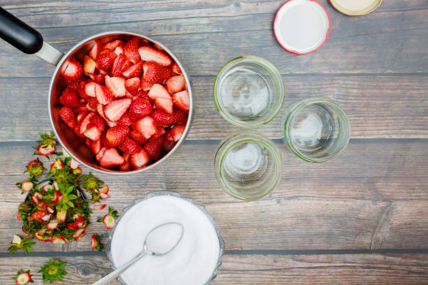 istock Cleaning and slicing fresh strawberries for making jam 1474733187