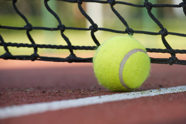 istock Tennis scene with black net, ball on white line 1474735055