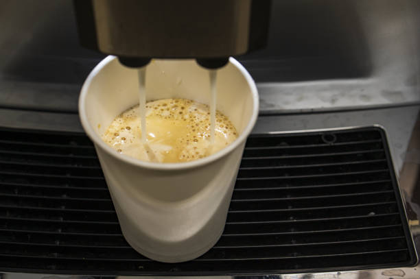 istock glass with cappuccino in the coffee machine 1474735119