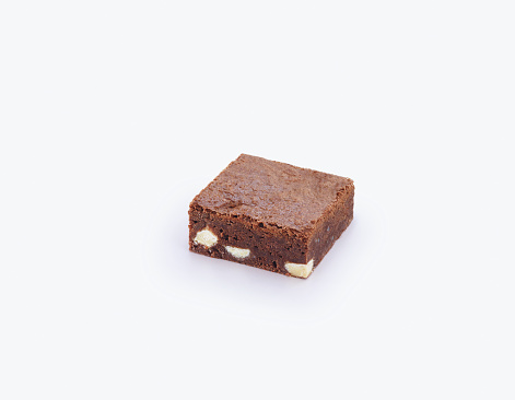 a slice of delicious chocolate and almond brownie. on white background