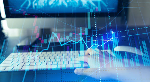 istock Golden bitcoins. Cryptocurrency on computer desk and Double Exposure chart 1474736335