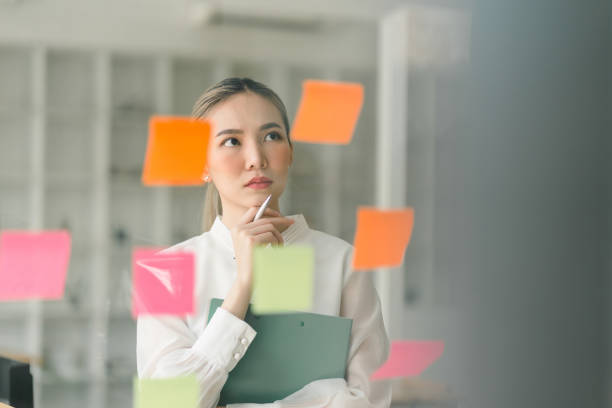 istock In a creative office, a startup young and confident businesswoman is strategizing using adhesive notes. 1474738783
