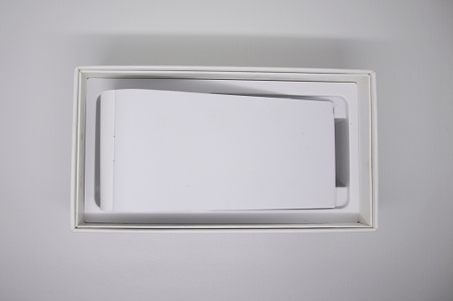 Blank paper in white box high angle shot. creative stock photos