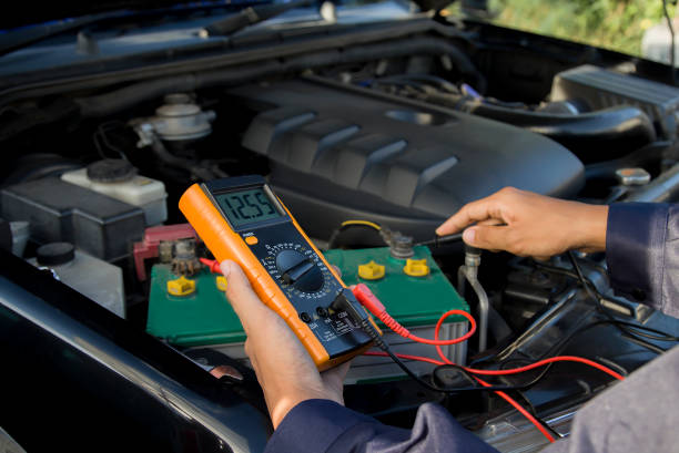 istock A technician is checking the car battery for availability. 1474740179