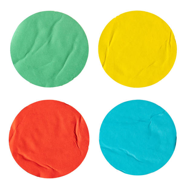 Round green, yellow, red and blue paper stickers stock photo